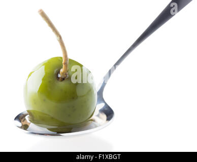 Olives in a spoon on a white background. Stock Photo