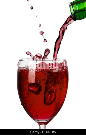 pouring red wine into a glass on white background Stock Photo