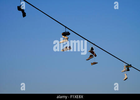 Pairs of shoes hanging from on a wire in Prague, Czech Republic Stock Photo