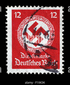 GERMANY - CIRCA 1944: A postage stamp printed in Germany shows the Swastika in an oak wreath, circa 1944. Stock Photo