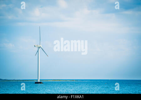 Single windmill in the oceran by the coast Stock Photo - Alamy