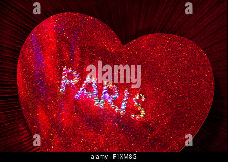 Sparkling jewel PARIS motif on red sparkling heart with multicolored lighting Stock Photo