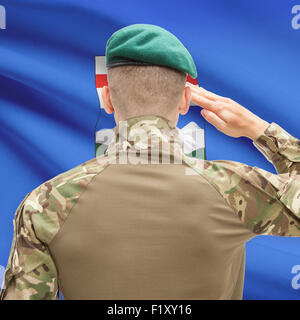 Soldier saluting to Canadial province flag series - Alberta Stock Photo