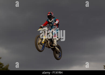 Motocross rider jumps high against a beautiful sky Stock Photo