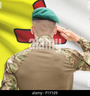 Soldier saluting to Canadial province flag series - Nunavut Stock Photo