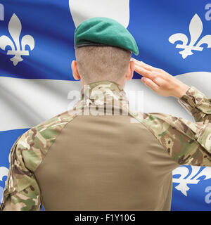 Soldier saluting to Canadial province flag series - Quebec Stock Photo