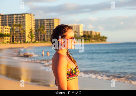 Tourist at Kaanapali Beach on Maui at sunset Stock Photo