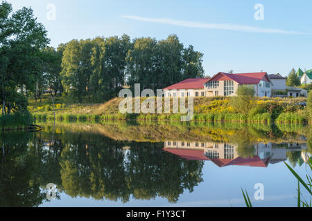 New brick house on the lake (pond) Stock Photo