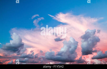 Dramatic colorful cloudscape, summer evening sky background with different types of clouds: cirrus, altocumulus, nimbostratus, c Stock Photo