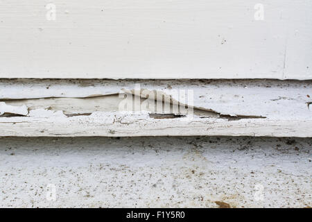 paint peeling from outside wooden window sill Stock Photo
