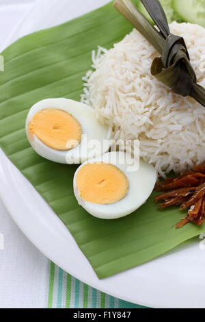 Boiled eggs served with coconut rice and fried anchovies Stock Photo