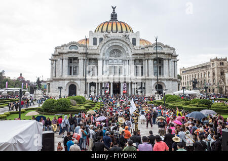 MEXICO CITY, Mexico — Visitors gather in the plaza before the iconic Palacio de Bellas Artes, Mexico's premier cultural center. The Art Deco masterpiece, completed in 1934, provides a dramatic backdrop for this vibrant public space in Centro Histórico. The plaza serves as a popular meeting point and cultural hub near the Alameda Central park. Stock Photo