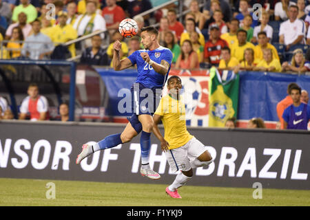 Foxborough, Massachusetts, USA. 8th Sep, 2015. United States defender Geoff Cameron (20) twists to head the ball away as Brazil midfielder Douglas Costa (7) watches during the Brazil vs USA International friendly match held at Gillette Stadium in Foxborough, Massachusetts. Brazil defeats the USA 4-1. Eric Canha/CSM/Alamy Live News Stock Photo
