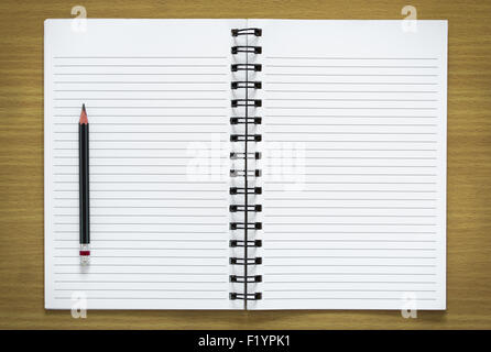 blank spiral notebook and pencil on wood background Stock Photo