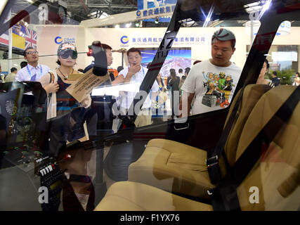 Tianjin, China. 9th Sep, 2015. Visitors gather to watch a helicopter at the Tianjin International Helicopter Exhibition in a helicopter base of Aviation Industry Corporation of China in the Airport Area of China Pilot Free Trade Zone of Tianjin, north China, north China, Sept. 9, 2015. The exhibition displayed 56 helicopters and attracted 366 enterprises. Credit:  Zhang Chenlin/Xinhua/Alamy Live News Stock Photo