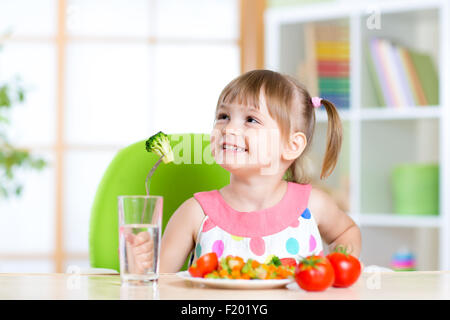 Kid eating healthy vegetables meal in home or nursery Stock Photo