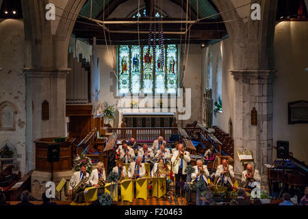 A Local Band Plays Music In St Andrew's Church In Alfriston During The Annual Village Fete, Alfriston, East Sussex, UK Stock Photo