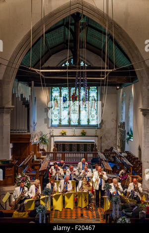 A Local Band Plays Music In St Andrew's Church In Alfriston During The Annual Village Fete, Alfriston, East Sussex, UK Stock Photo