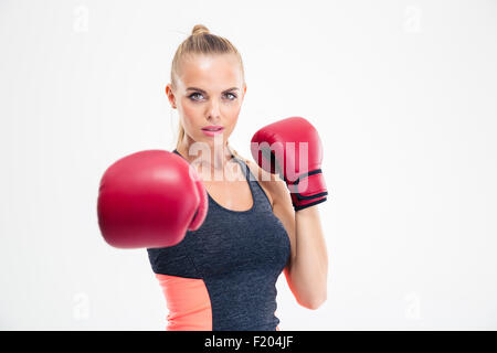 Portrait of a charming woman hitting at camera in boxing gloves isolated on a white background Stock Photo