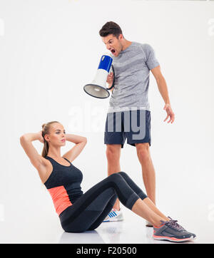 Portrait of woman pilates trainer doing exersices on the Ladder