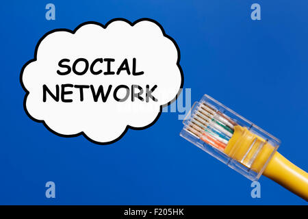 Social Network Concept. LAN cable connecting into a social network represented as a cloud on a plain sky blue background. Stock Photo