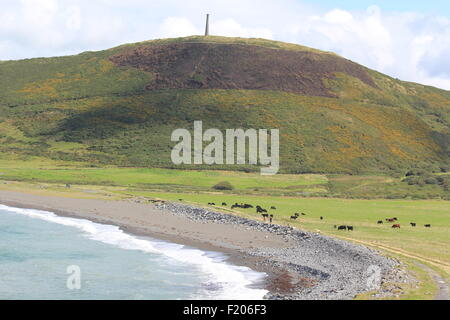 Pen dinas hill fort and the duke of wellington monument in the shape of a cannon nr Aberystwyth as seen from tan y bwlch beach Stock Photo