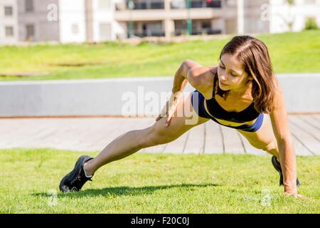 Young woman exercising in park Stock Photo
