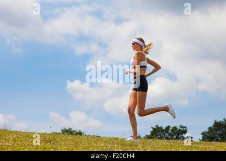 Woman jogging in countryside Stock Photo