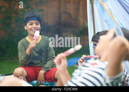 Download Girl and two brothers eating ice lollies in front of ... Yellowimages Mockups