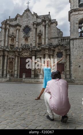 Young couple taking photographs in the colonial Plaza de la Cathedral of Havana, Cuba Stock Photo