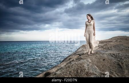 Young woman strolling along clifftop, Costa Rei, Sardinia, Italy Stock Photo