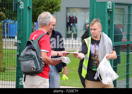 Shirebrook, Derbyshire, UK. 9 Sept 2015. Sports Direct workers are leafleted by Unite union members as they emerge from their shift at the company’s headquarters and warehouse in Shirebrook where the company today held its Annual General Meeting. The protest is part of a national day of action outside Sports Direct stores across the UK. Credit:  Deborah Vernon/Alamy Live News Stock Photo