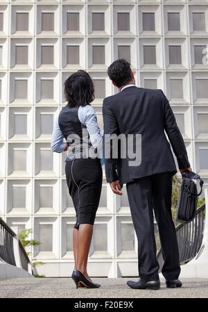 Low angle full length view of business people, looking up Stock Photo