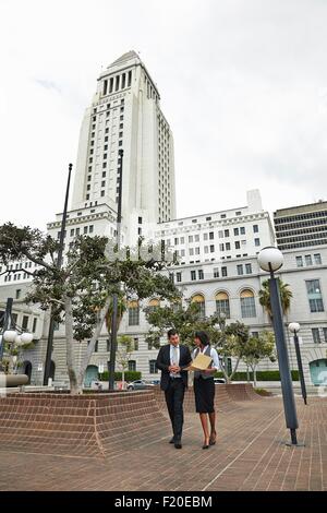 Business people walking across tiled floor, Los Angeles City Hall, California, USA Stock Photo
