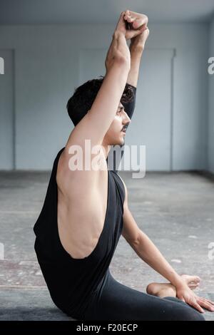 Dancer stretching in studio Stock Photo