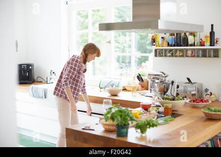 Woman preparing meal in kitchen Stock Photo