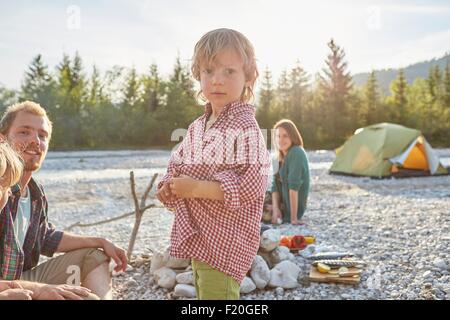 Portrait of boy with parents on camping trip, looking at camera Stock Photo