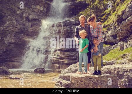Two generation family having fun by waterfall, Ehrwald, Tyrol, Austria Stock Photo