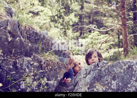 Boy peeking out from behind wall Stock Photo - Alamy