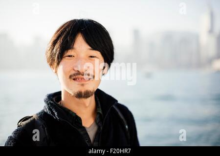 Portrait of mid adult man with goatee and mustache looking at camera smiling Stock Photo