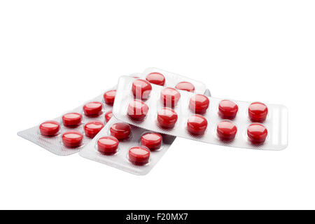 Isolated red pills in foil  blister pack on a white background Stock Photo