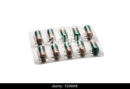 Green medication capsules in blister pack on whiite background Stock Photo