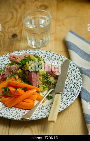 Ham hock with split peas and carrots. a UK lunch dinner meal cooking cuisine plate dish Stock Photo