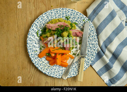 Ham hock with split peas and carrots. a UK lunch dinner meal cooking cuisine plate dish Stock Photo