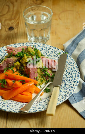 Ham hock with split peas and carrots. a UK lunch dinner meal cooking cuisine plate dish Stock Photo