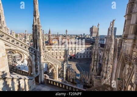 Italy, Lombardy, Milan, the arrows and statues of Duomo seen since the terrace situated on the roof of the cathedral with a view of the Palazzo Reale museum, the church San Gottardo in Corte or San Gottardo a Palazzo and the tower Velasca Stock Photo