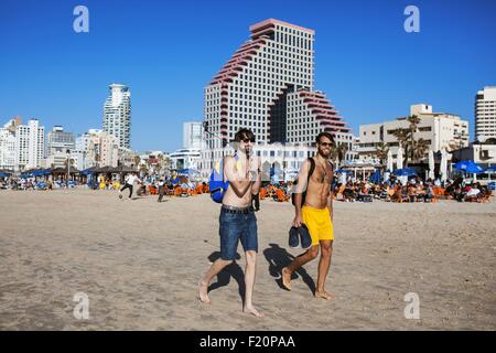 Israel, Tel Aviv, boys walking in the beach Stock Photo