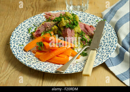 Ham hock with split peas and carrots. a UK lunch dinner meal cooking cuisine plate dish Stock Photo