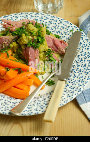 Ham hock with split peas and carrots. a UK lunch dinner meal cooking cuisine plate dish Stock Photo