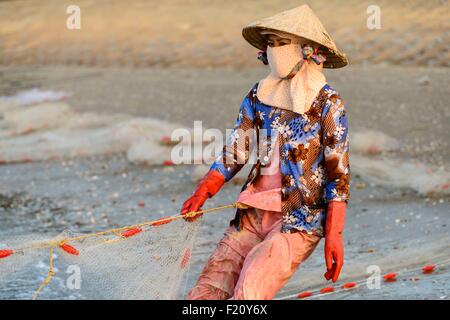 Fishermen hauling in their Seine fishing nets from the ocean onto